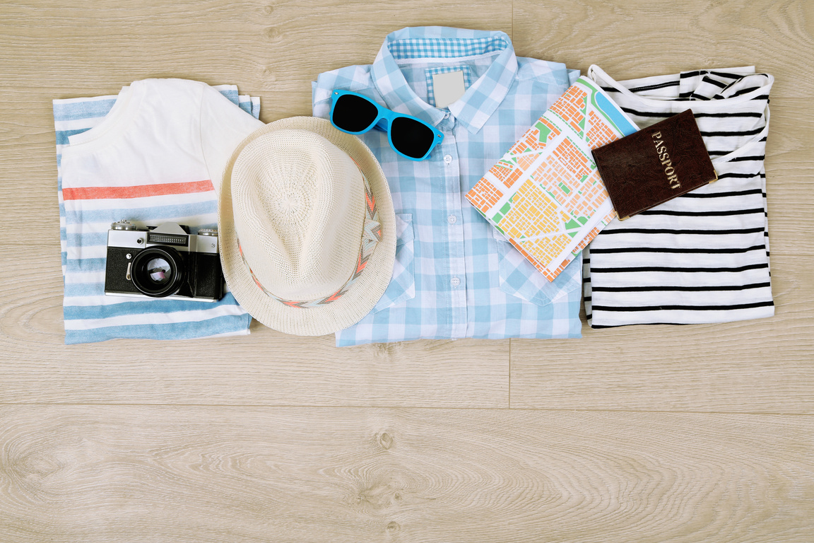 Summer Vacation Clothes, Shoes and Hat on Wooden Background